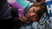 A Syrian refugee girl napping inside a tent in Greece